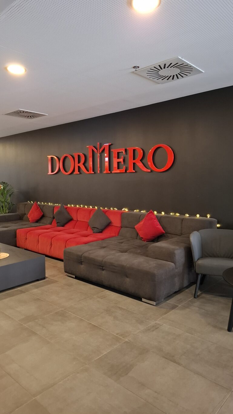 A highly modern, comfortable hotel bedroom featuring vibrant LED lighting at the Dormero