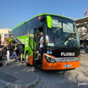 Passengers boarding a green double-decker FlixBus coach at Kelenföld station