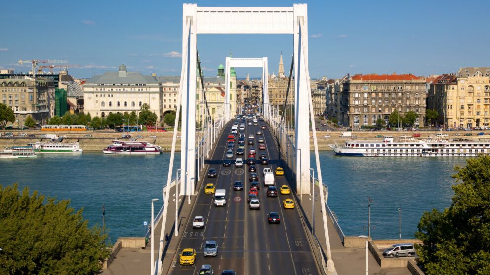 The white Erzsébet Bridge spanning the Danube leading directly to the green slopes of Gellért Hill
