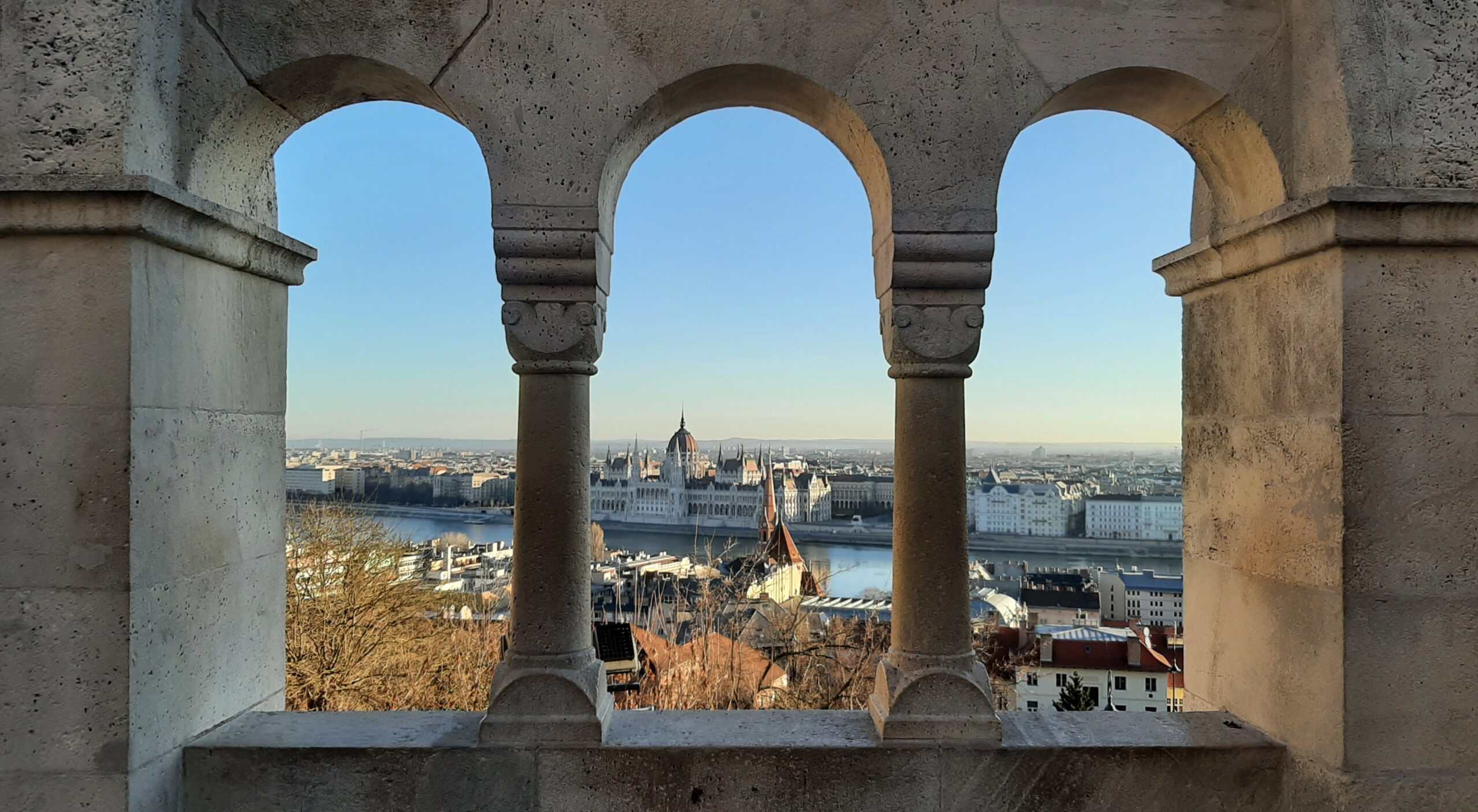 A wide daytime panorama taken from Fisherman's Bastion looking perfectly across the river toward the Parliament