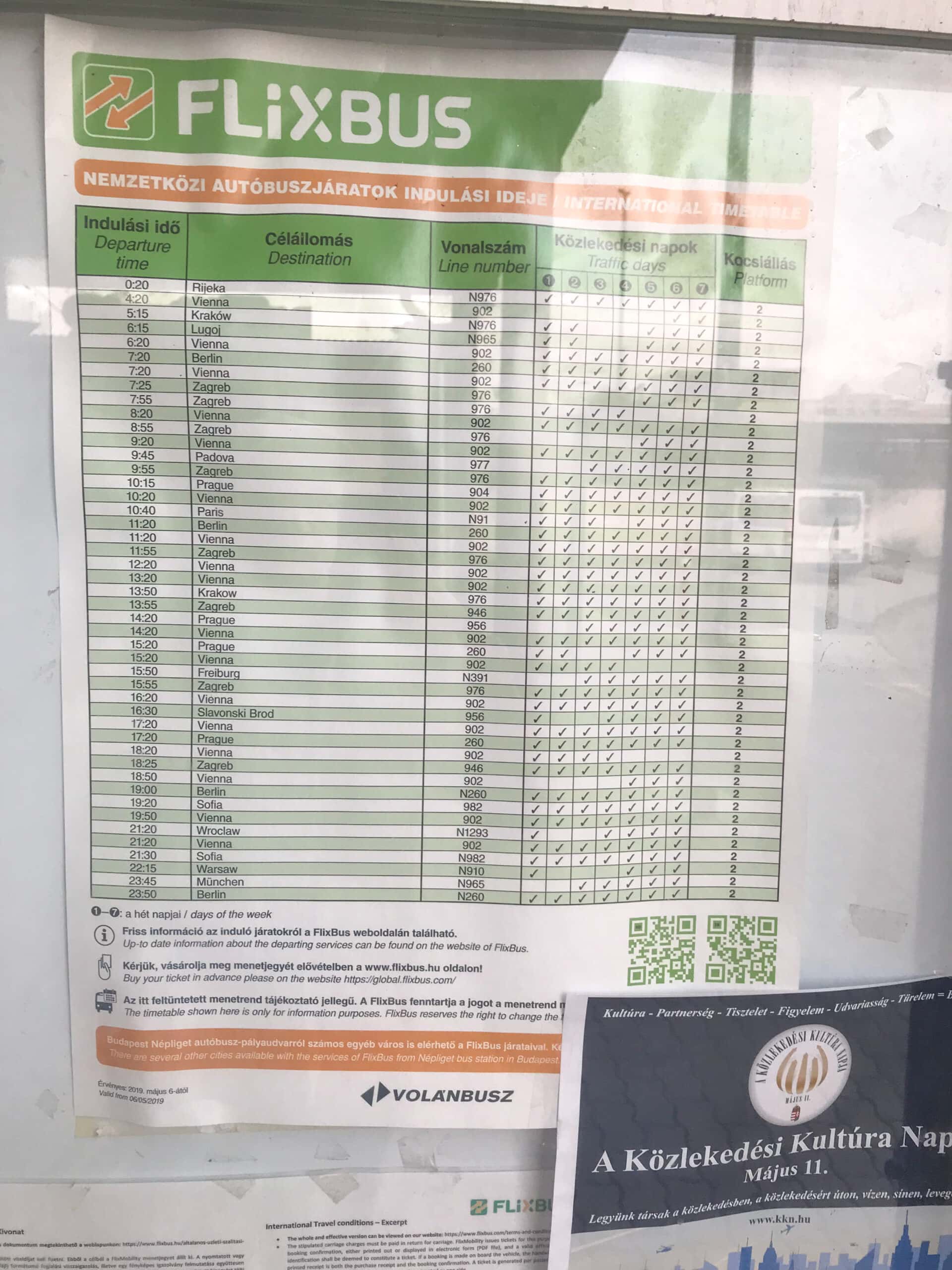 A printed FlixBus departure schedule attached to a post at the bus station