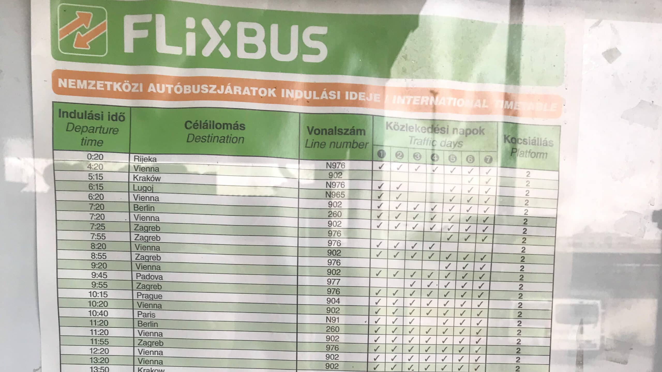 A printed FlixBus timetable showing frequent daily departures to Vienna
