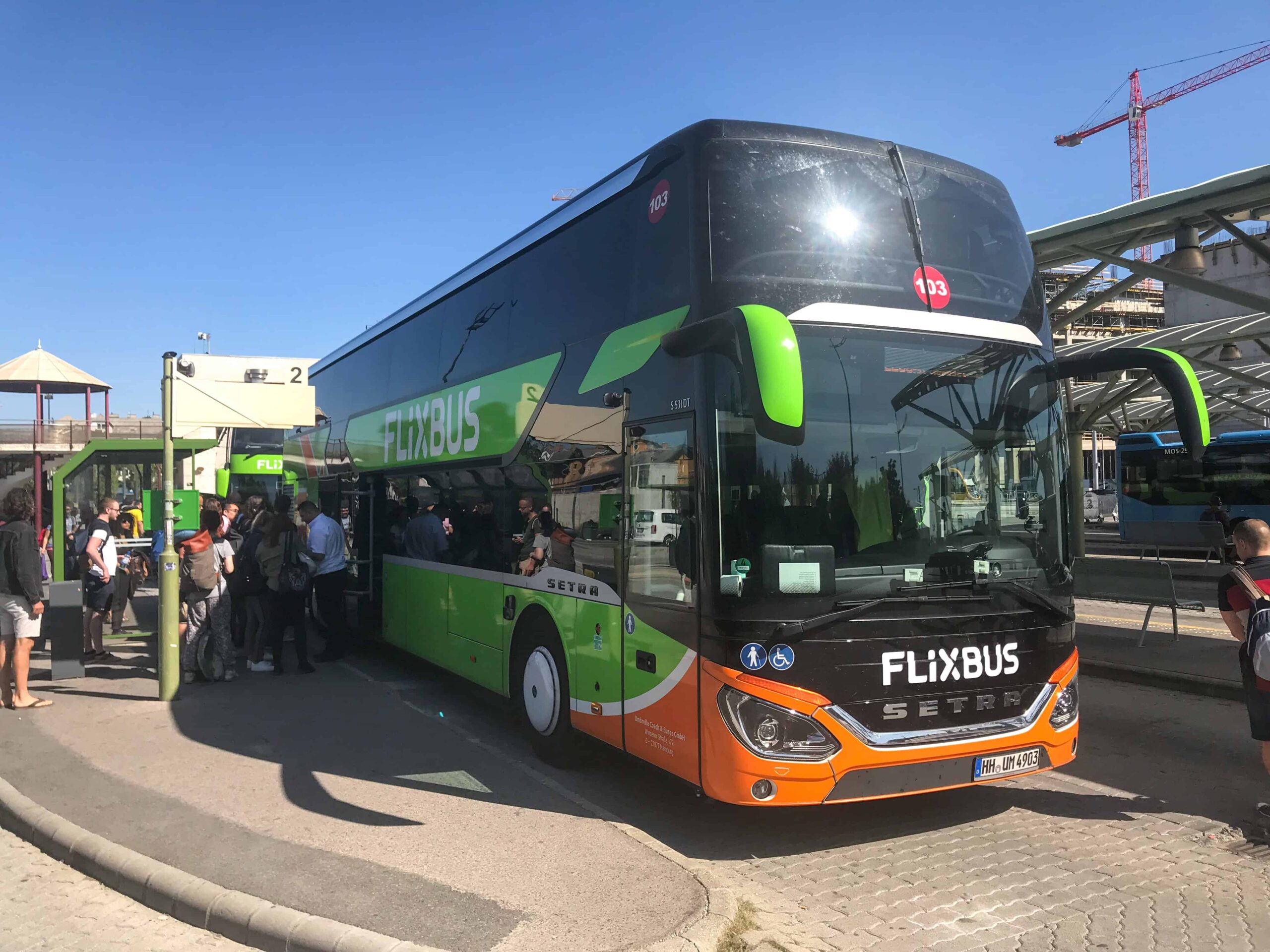 The official FlixBus stop sign and waiting area at Kelenföld station