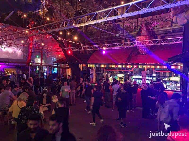 The main Fogasház courtyard covered entirely by a massive circus tent filled with dancers