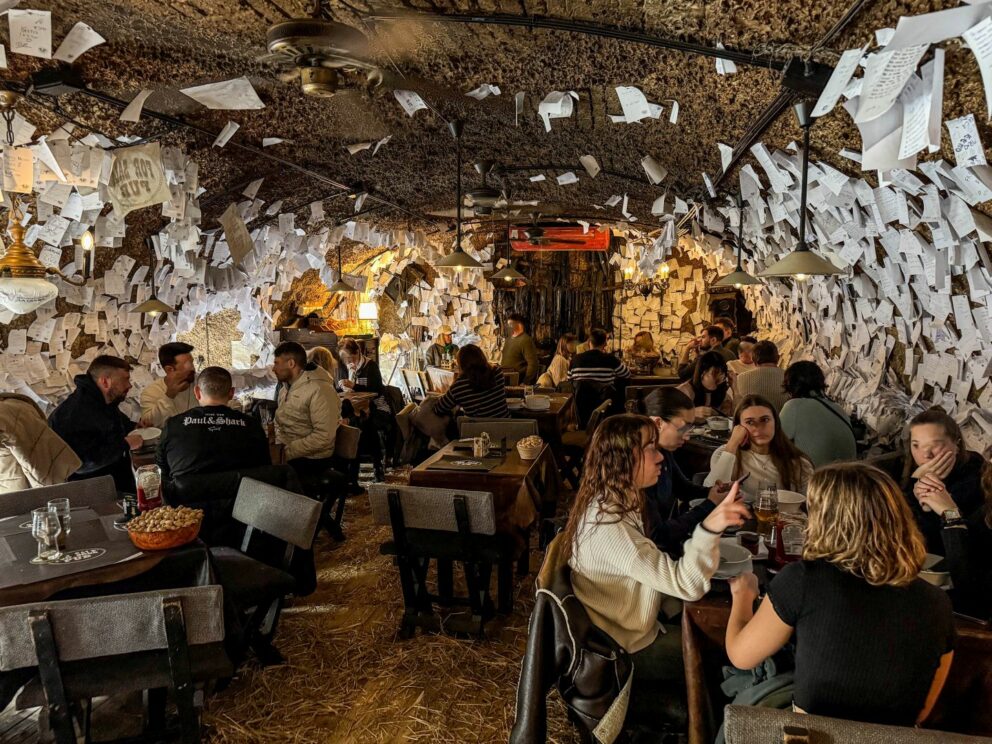 The bustling, tightly packed second-floor dining area of the pub filled with patrons