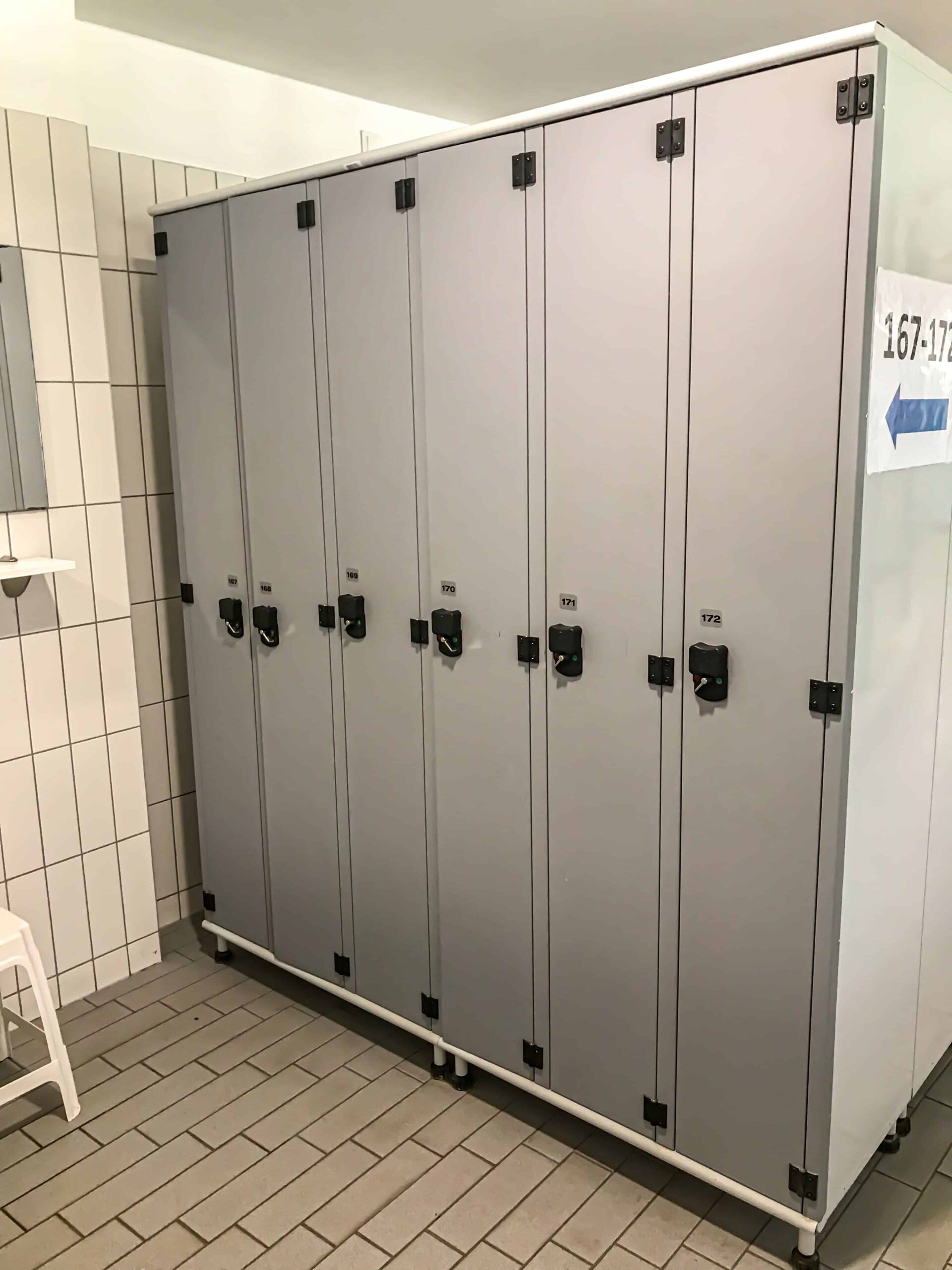 The vintage wooden changing cabins lining the hallway in the Gellért Bath locker room