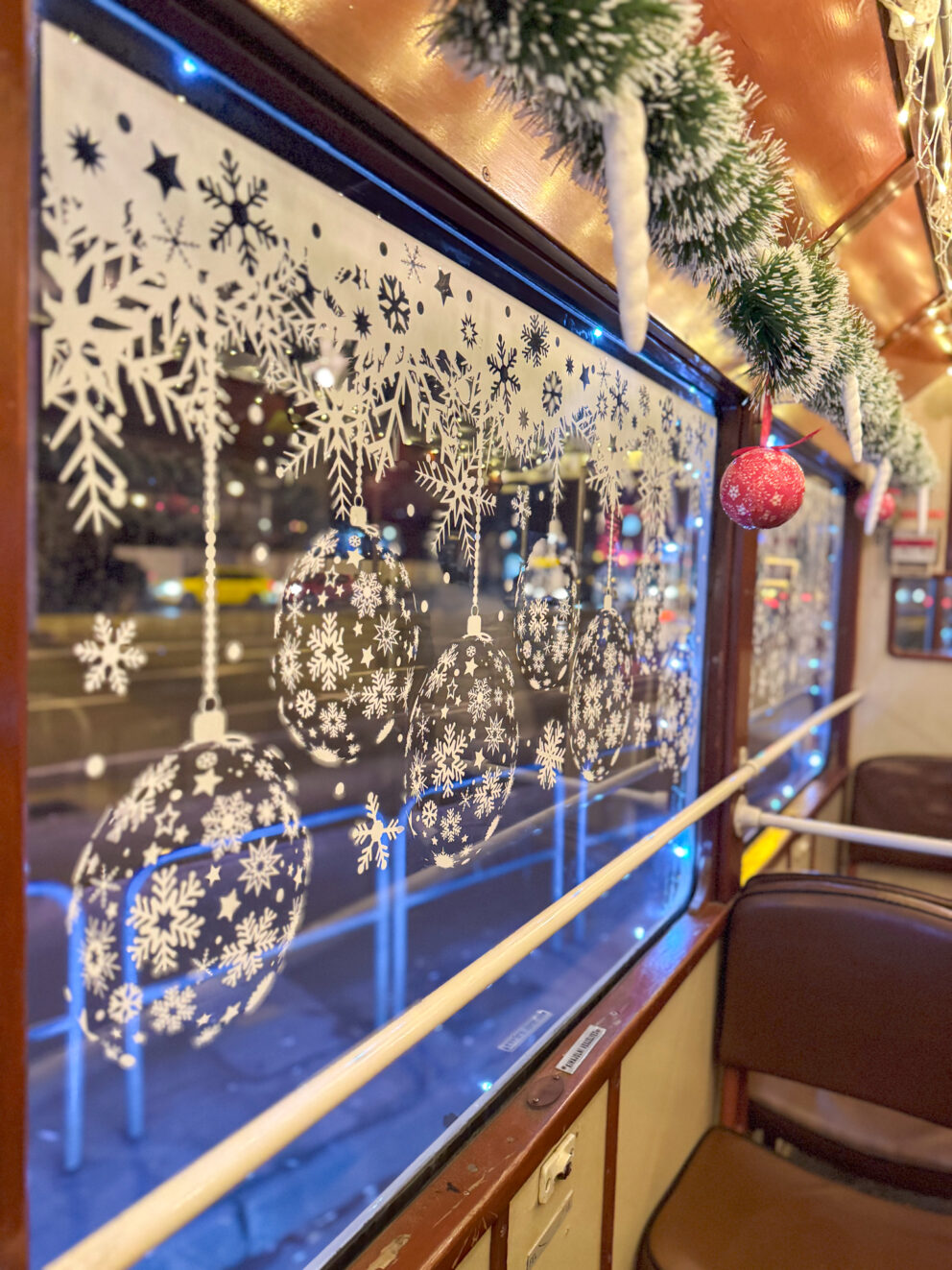 Close-up of thick strings of LED lights framing the vintage tram windows