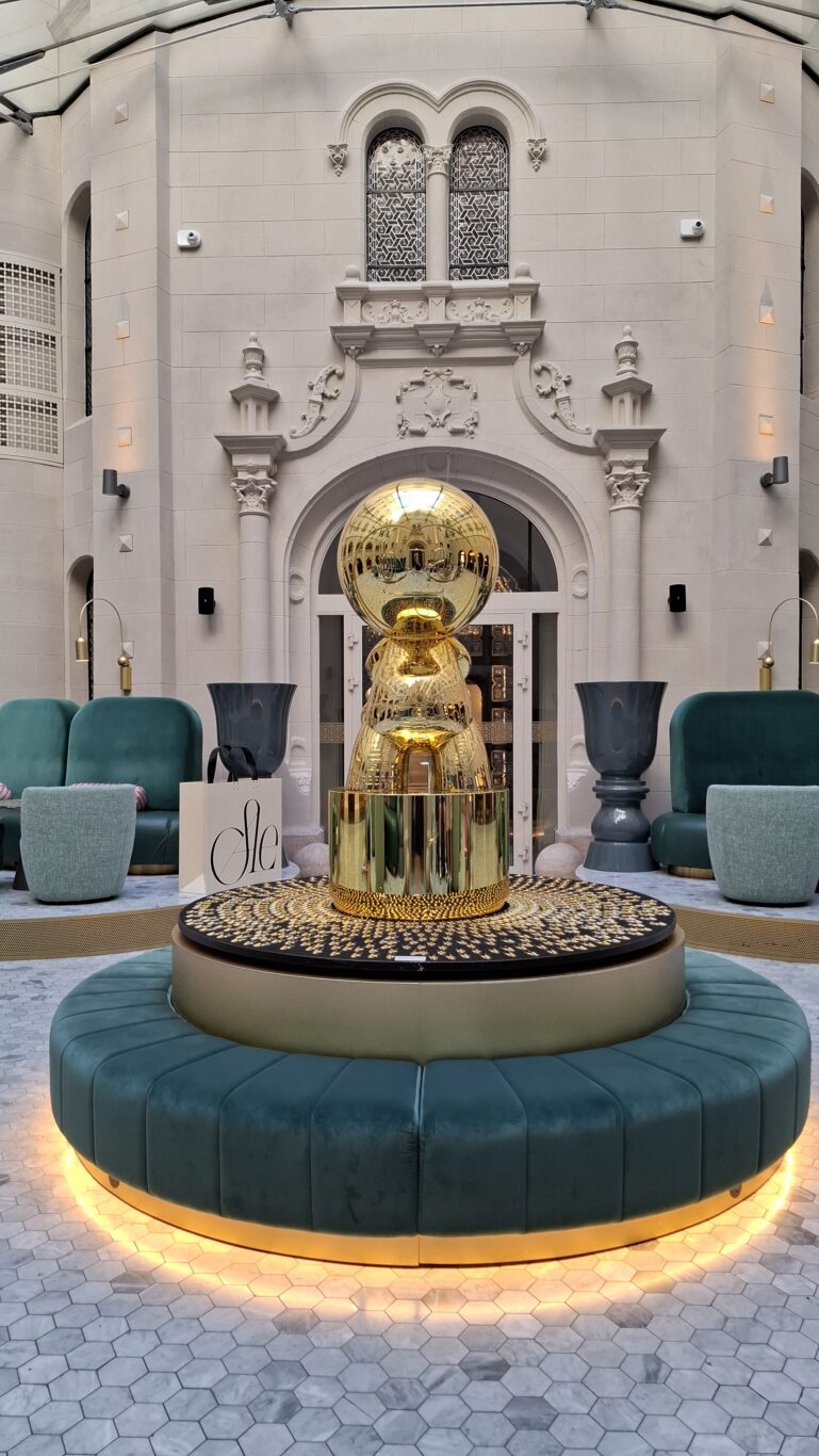 A modern gold sculpture in the central courtyard lobby of the W Budapest