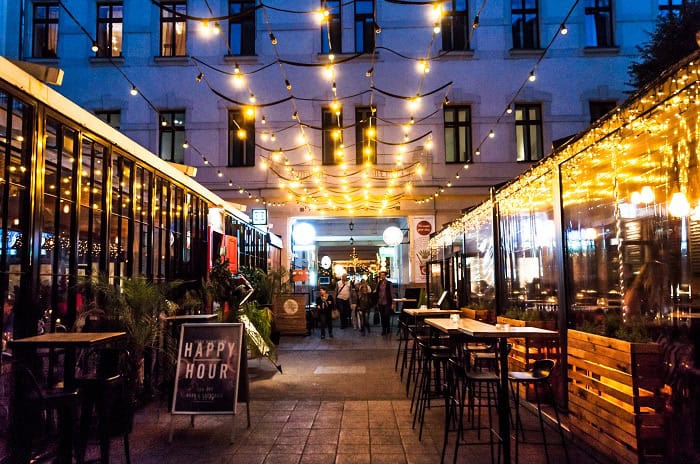 The bustling passage of Gozsdu Udvar filled with restaurants and lights