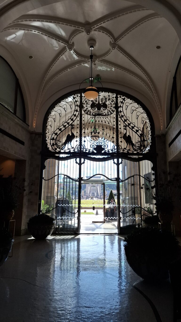 The warm, elegant, brass-lined marble cocktail bar inside the Gresham Palace