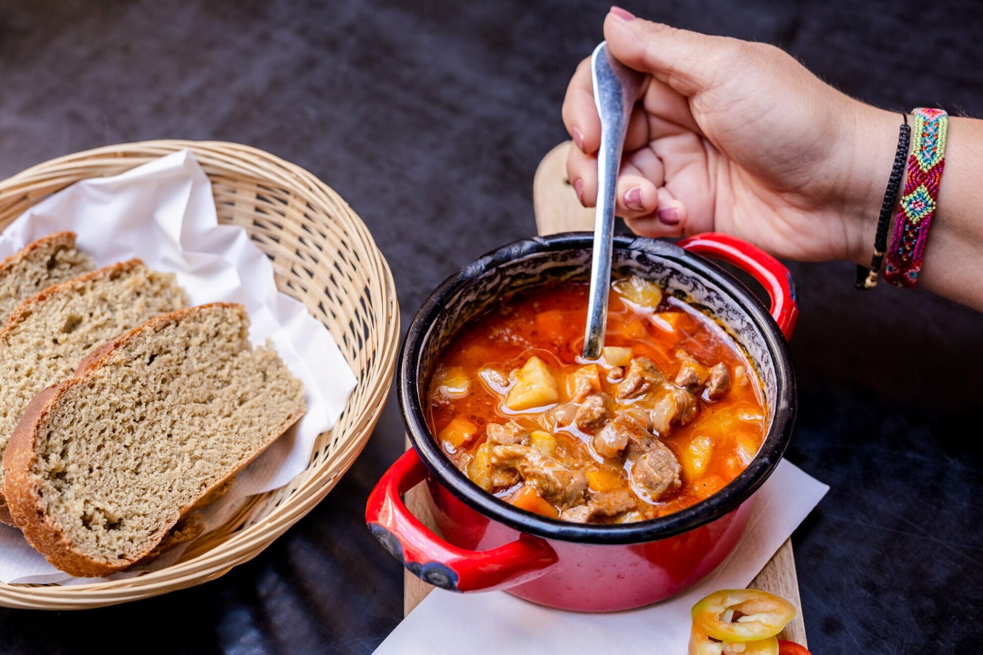 A bowl of Goulash Soup served with bread