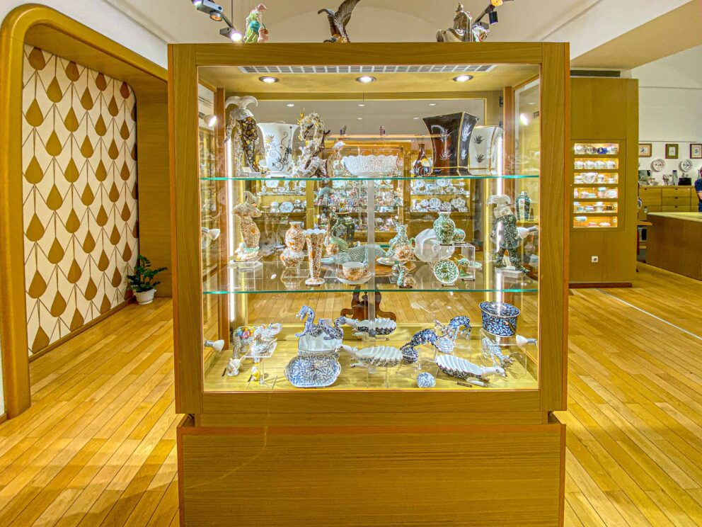 A highly detailed close-up of a hand-painted floral Herend teacup with 24-karat gold trim