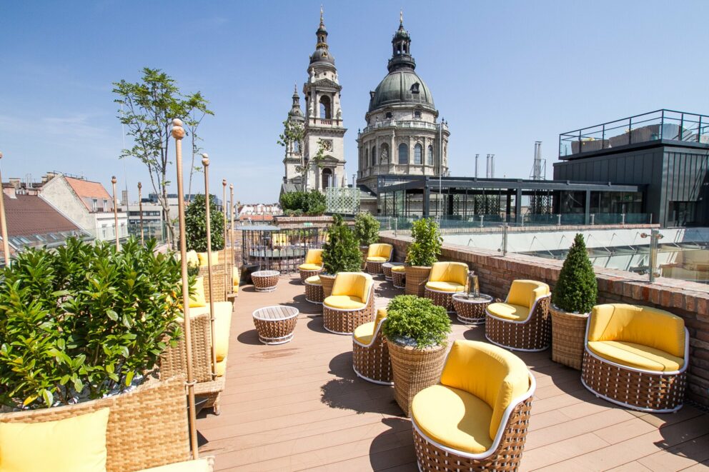 The vibrant yellow furniture and Basilica view at High Note SkyBar