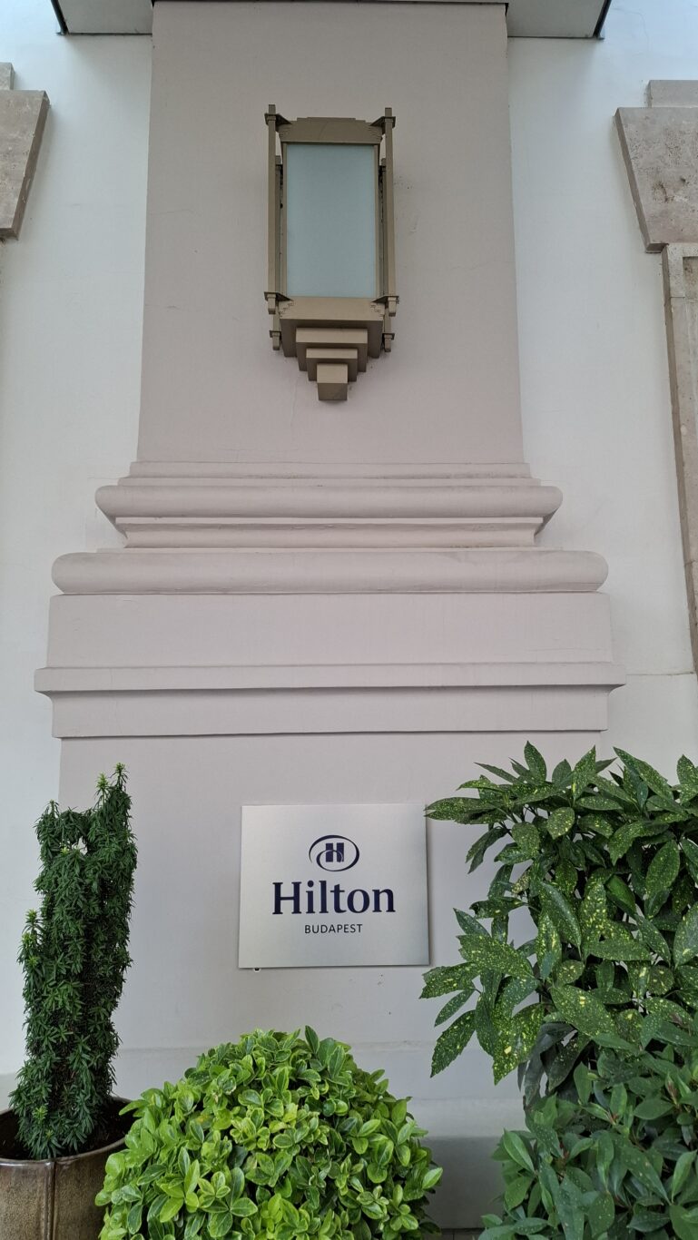 The sleek, marble-tiled luxury bathroom featuring a deep soaking tub inside a Hilton suite
