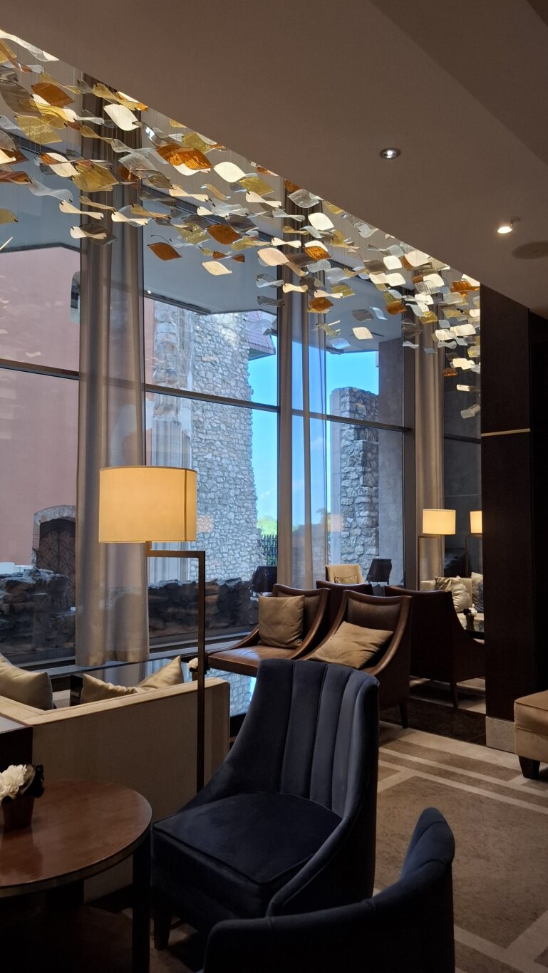 A modern, bright luxury guest room inside the Hilton Budapest featuring a king bed