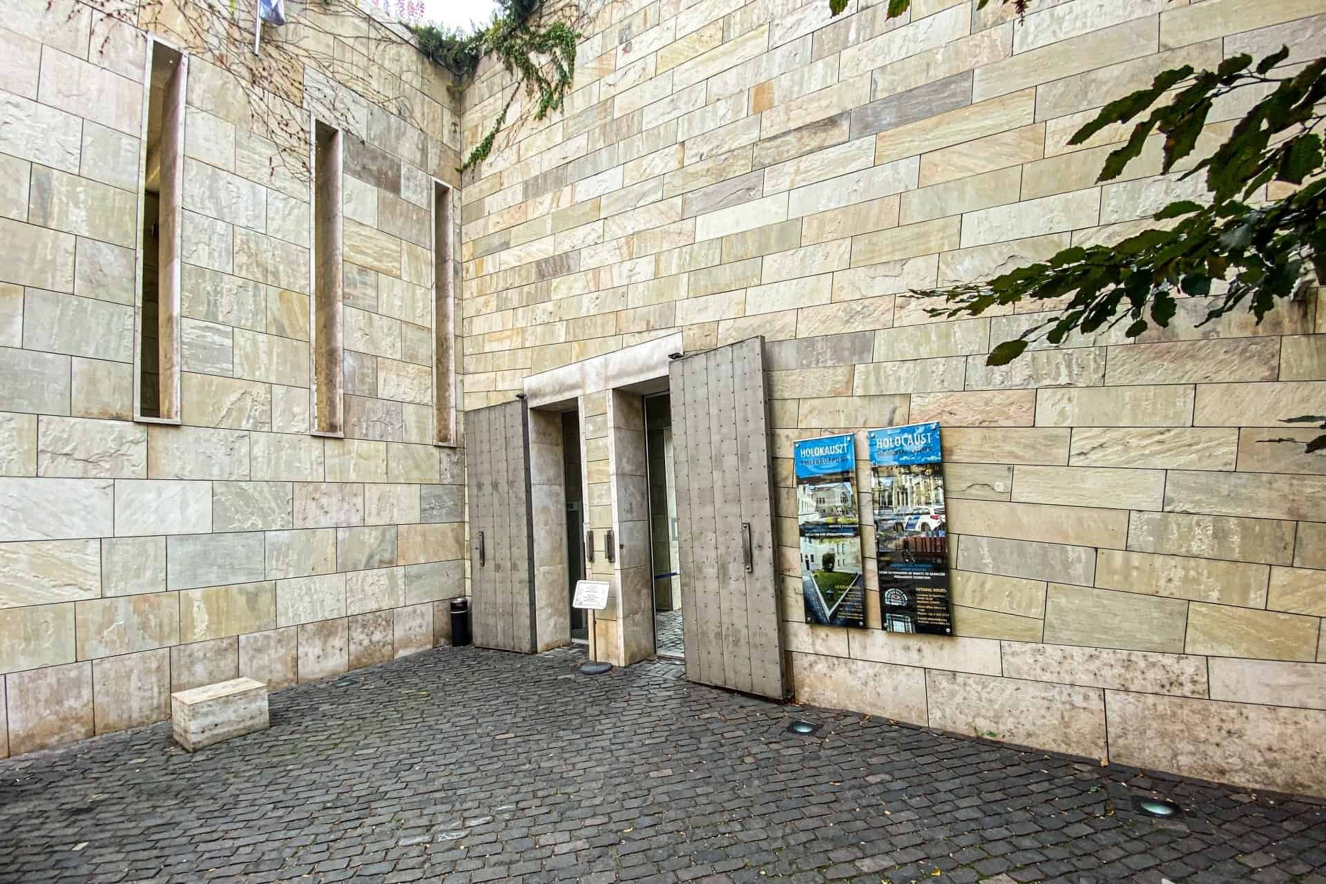 The stone entrance and heavy metal doors of the Holocaust Memorial Center in Budapest