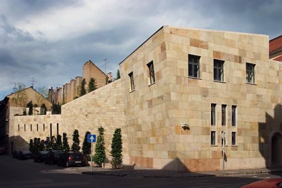 Illuminated glass display cases sitting in dim light inside the permanent exhibition