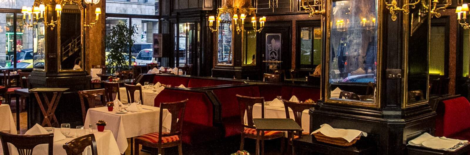 The very classic, traditional dark wood and crystal chandelier interior of the Astoria Hotel