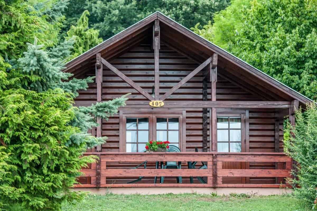 A smiling professional babysitter reading a picture book to toddlers in a hotel suite