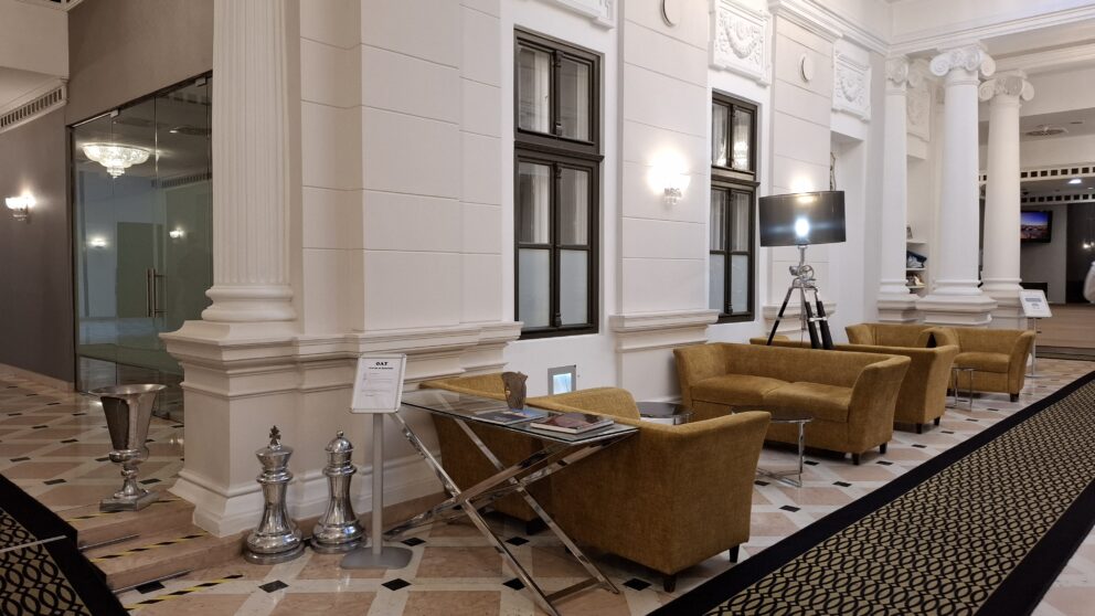 The elegant hotel lobby featuring comfortable armchairs and decorative silver chess pieces