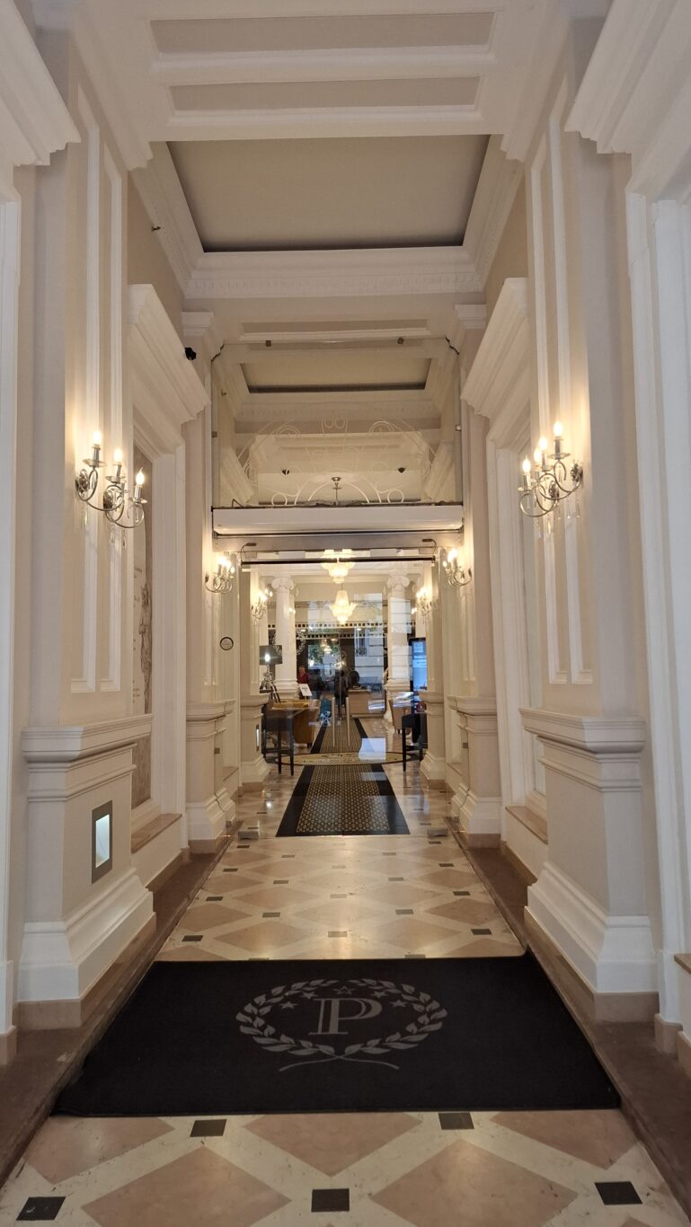 The refined hallway featuring a black carpet with the Hotel President logo