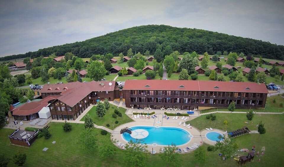 A spacious hotel family suite featuring a large parental bed and wooden bunk beds