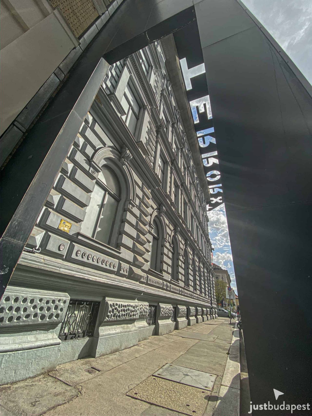 An authentic Soviet T-54 tank sitting in a pool of dark oil in the central courtyard