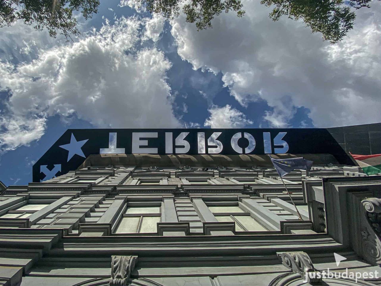 Hundreds of black-and-white portraits of victims lining the memorial wall