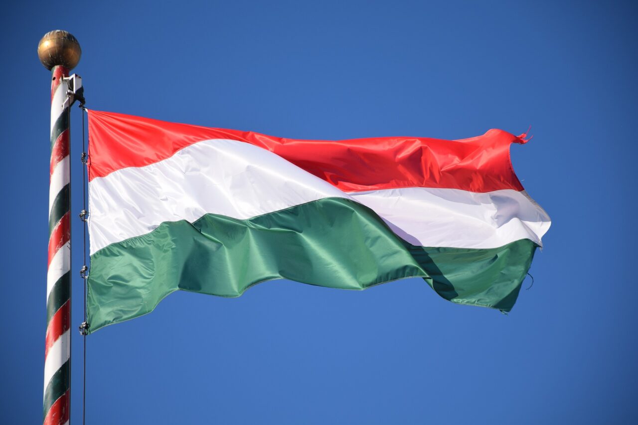 The red, white, and green horizontal stripes of the Hungarian national flag blowing in the wind