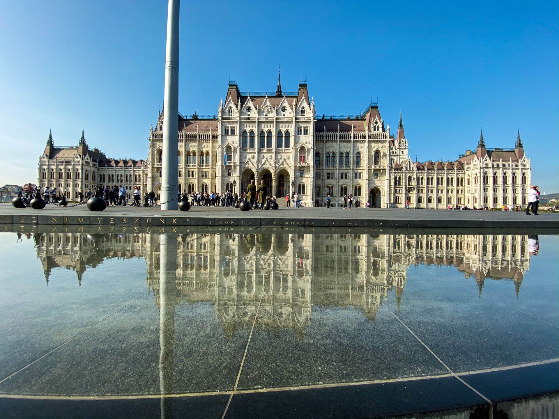 The perfect mirror reflection of the illuminated Parliament in the dark Danube waters