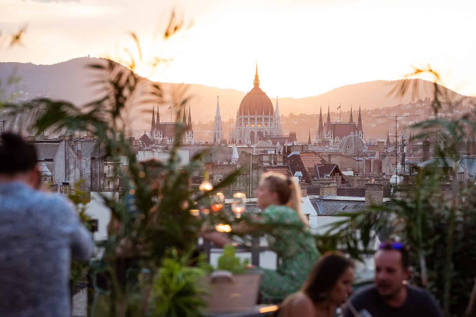 Stunning golden hour sunset view of the Hungarian Parliament from a rooftop terrace