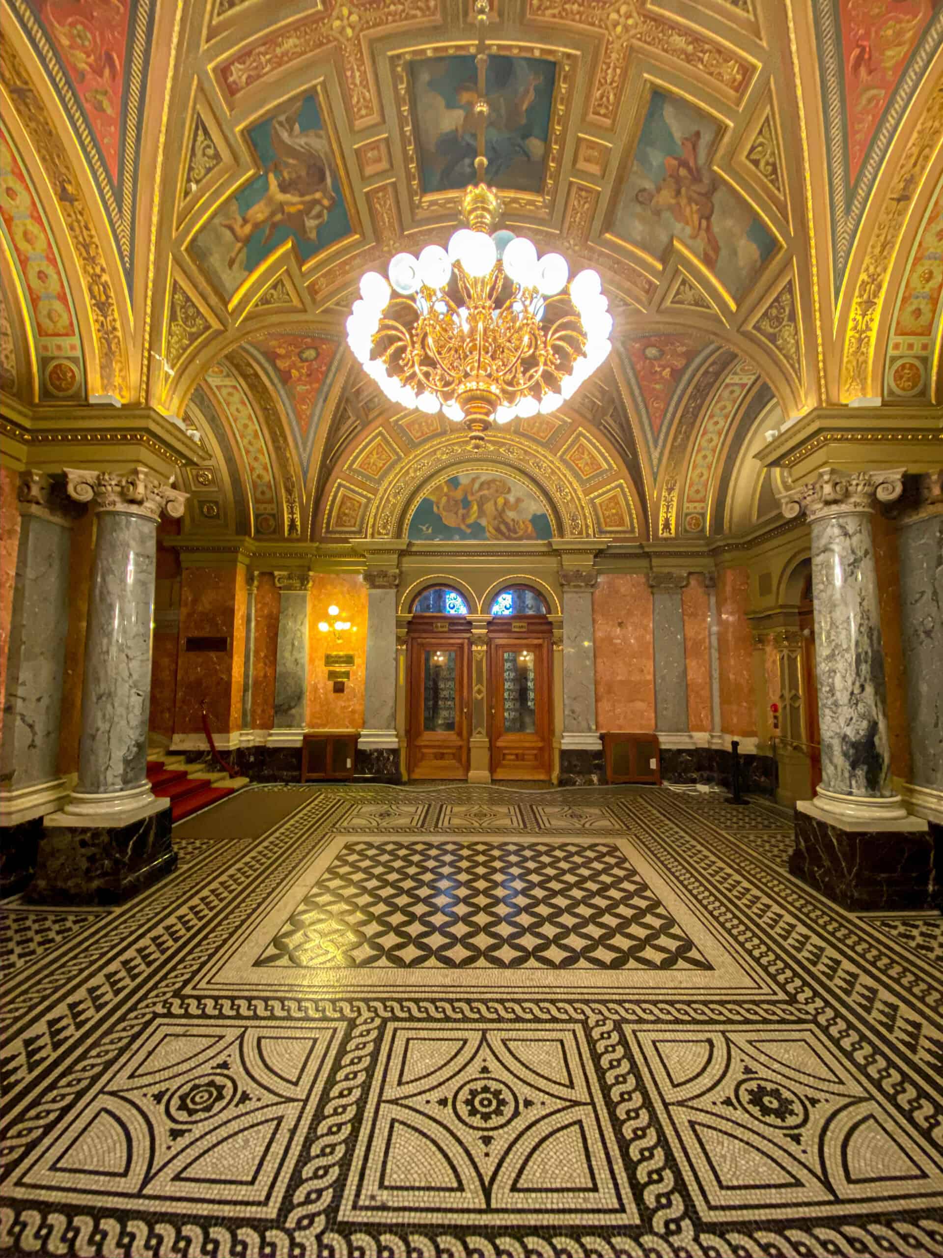 The highly ornate and gilded interior foyer of the Hungarian State Opera House