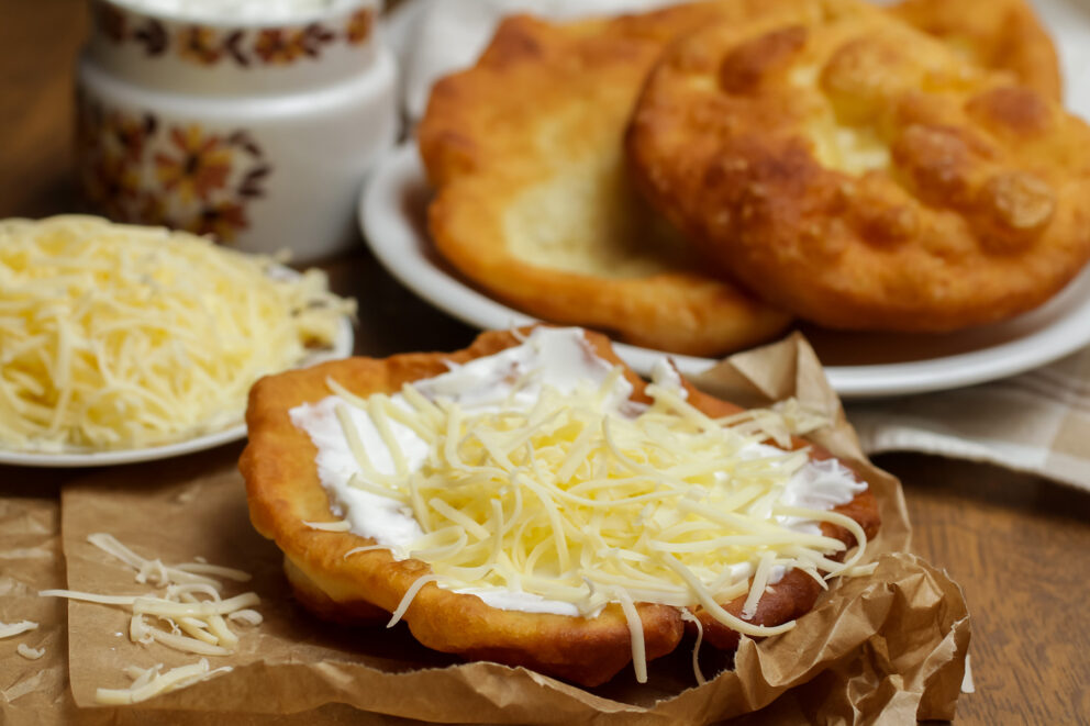 Lángos served with sour cream and cheese