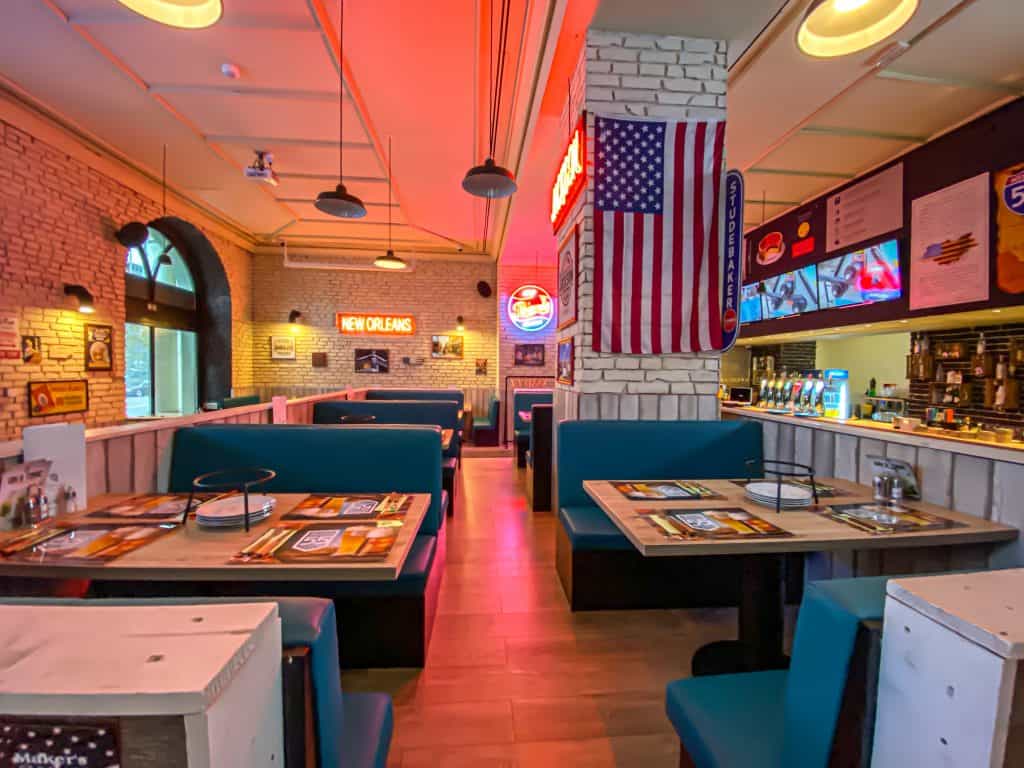 Vintage American neon signs and license plates decorating the brick walls of I55