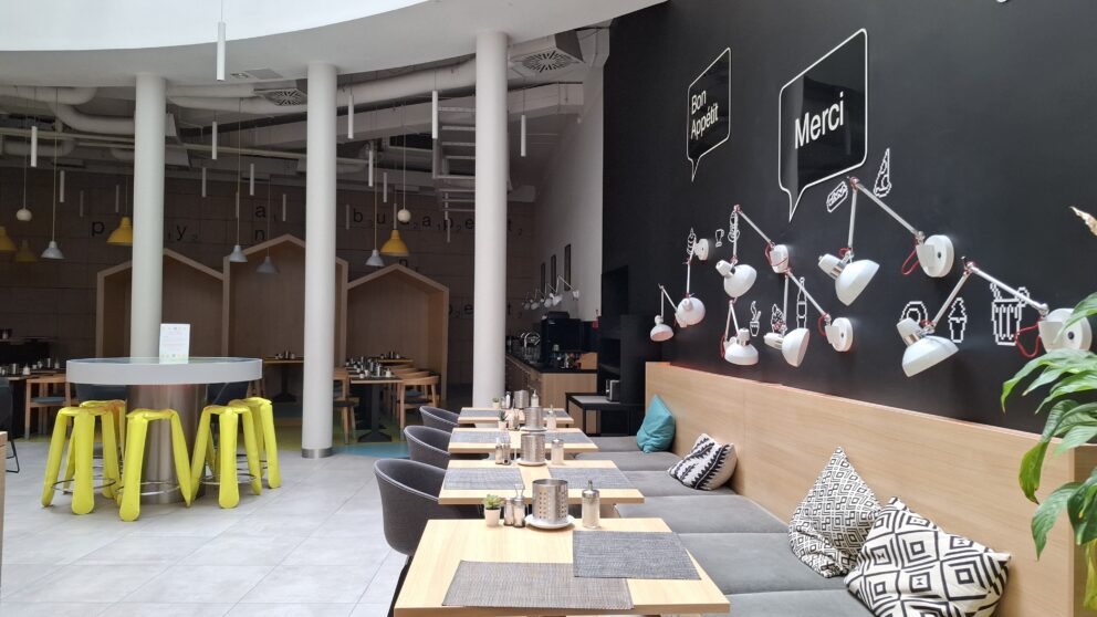 The spacious, vivid, brightly colored hotel breakfast dining area