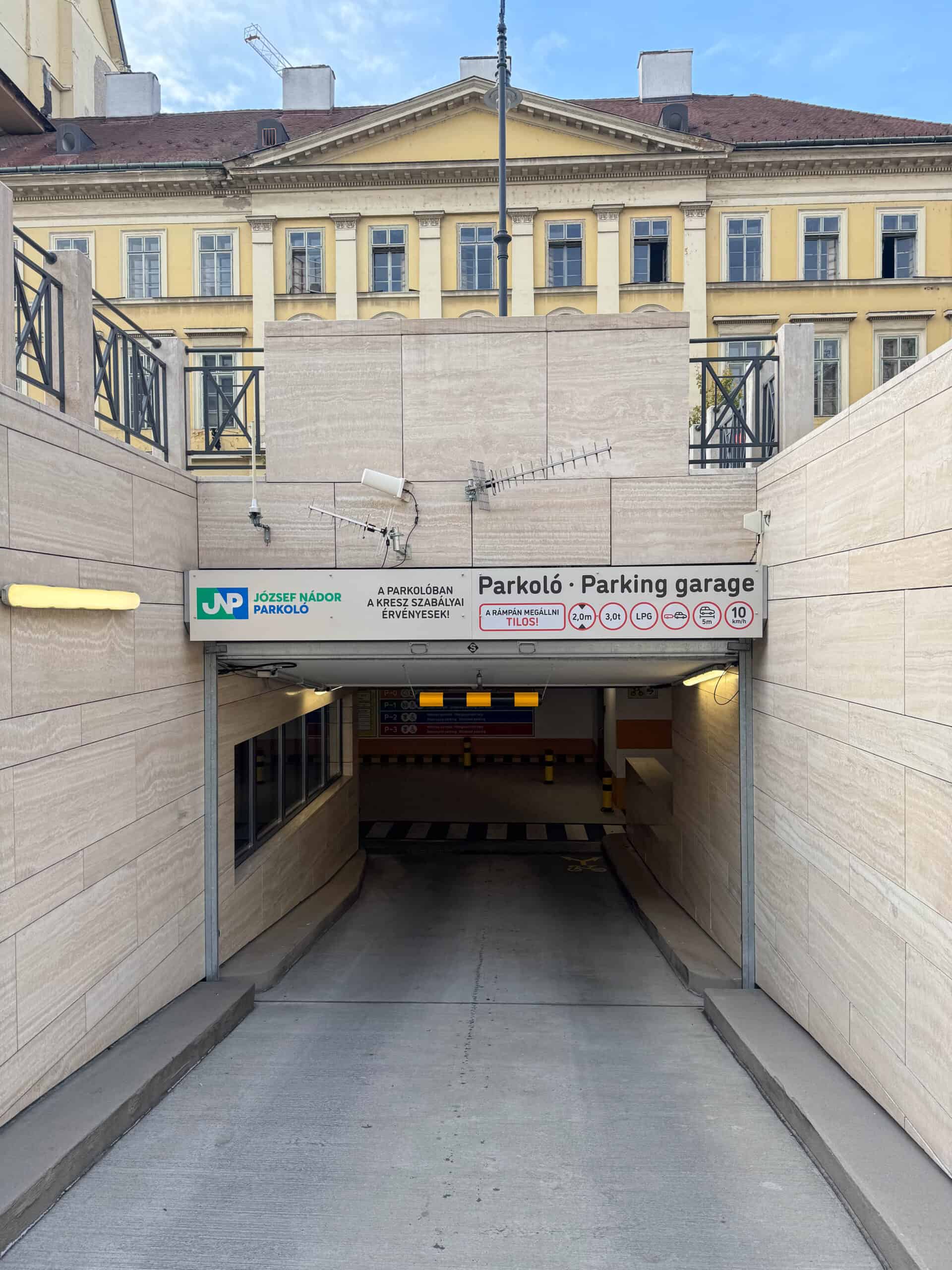 The entrance ramp leading down into the Jozsef Nador Square parking garage bearing restriction signs
