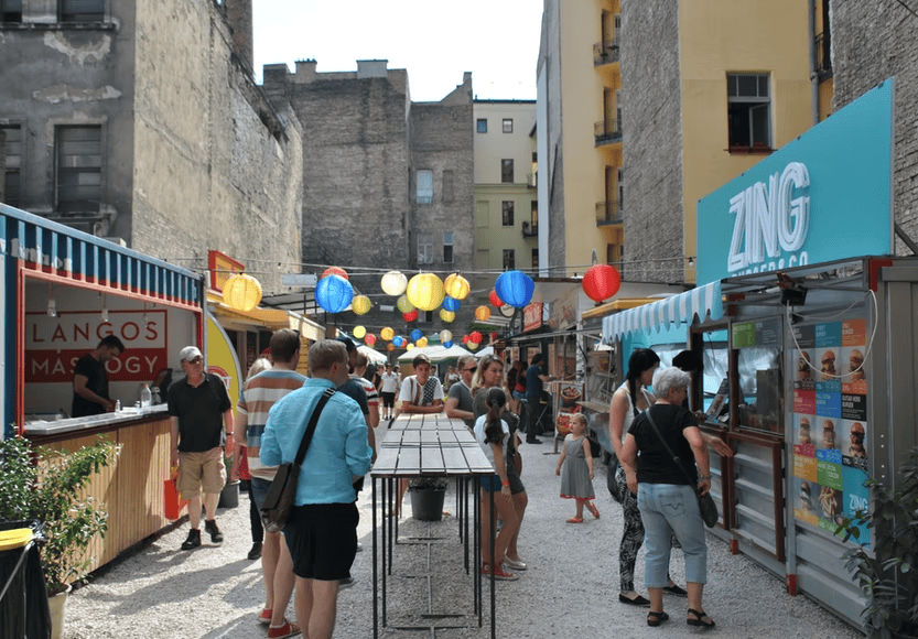 Food stalls and colorful lanterns inside the Karavan street food court