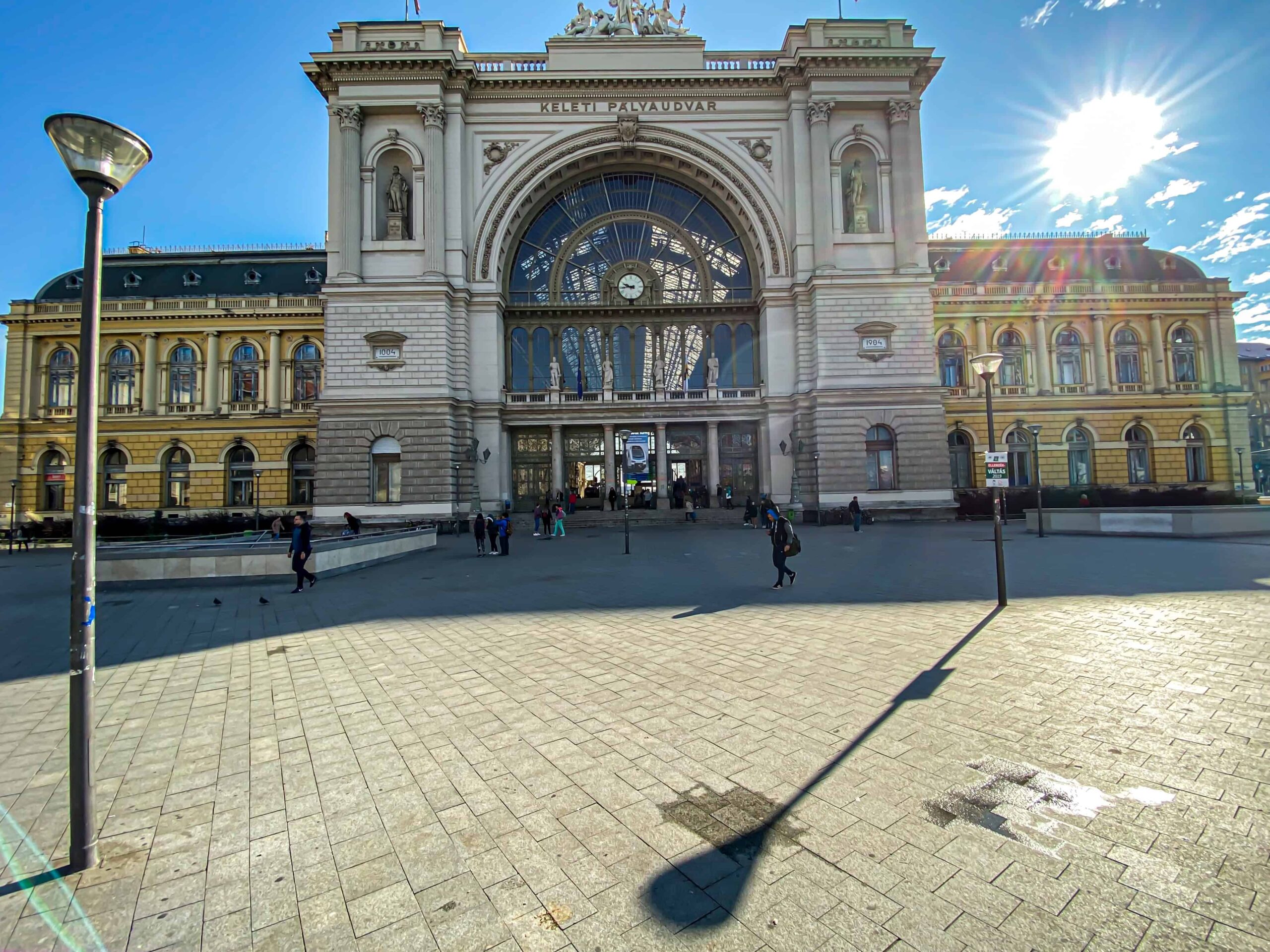 The grand classical facade and large square of Keleti Railway Station in Budapest