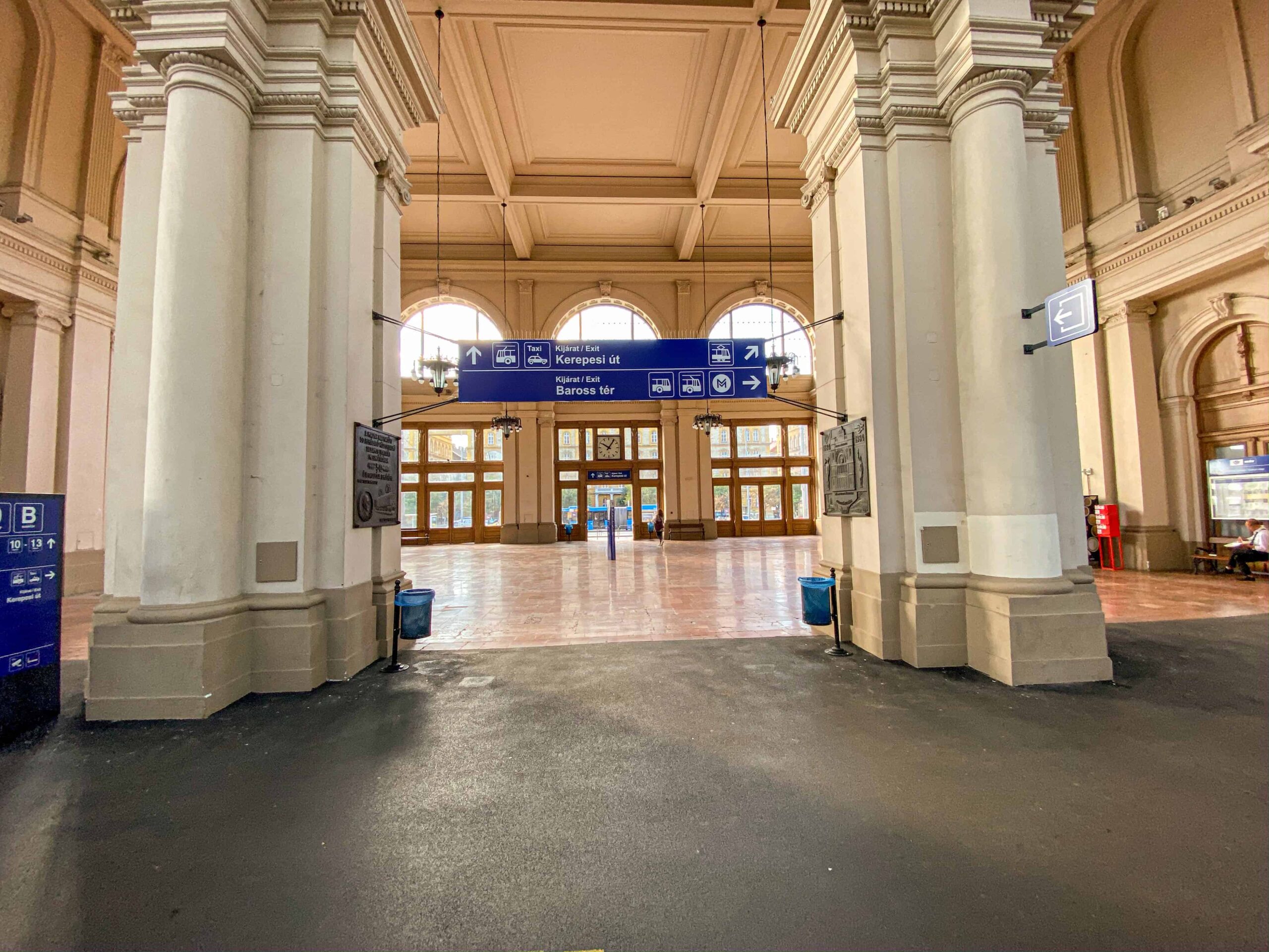 Interior of Keleti station showing directional exit signs for public transport