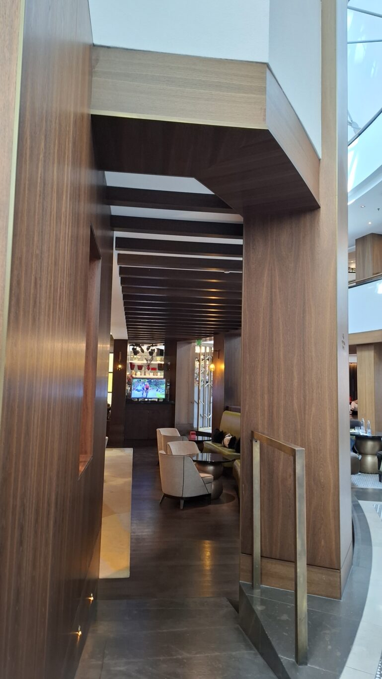 The massive, uniquely shaped main lobby concourse heavily flooded warmly with sunlight