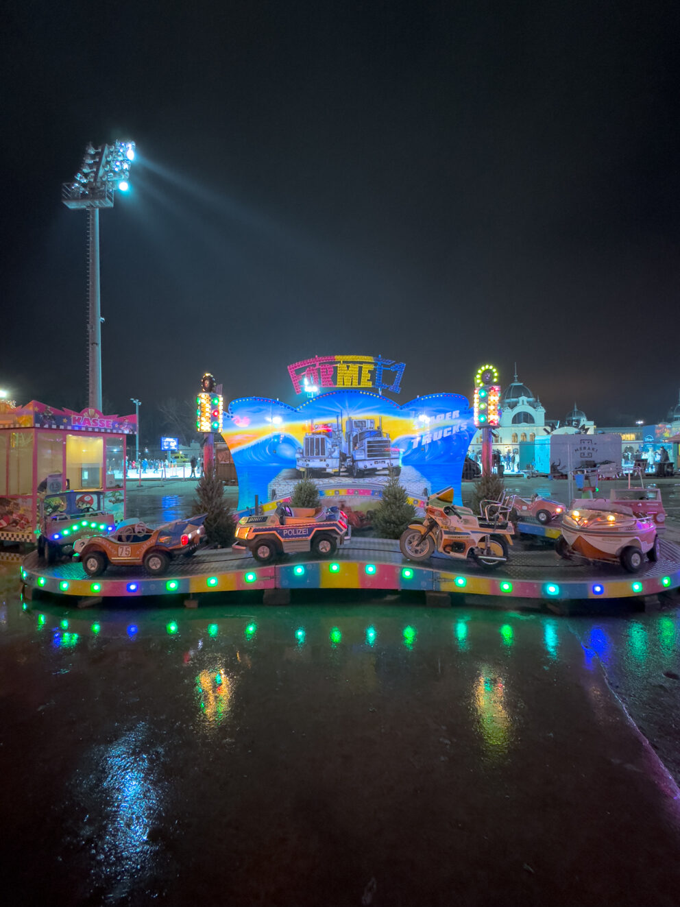 A small, brightly colored insect-themed children's coaster on a gentle track