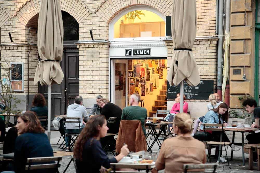 The intimate outdoor seating terrace directly outside the Kis Lumen cafe