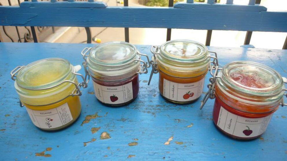 Beautifully rustic wooden shelves thoroughly packed with fresh artisan foods