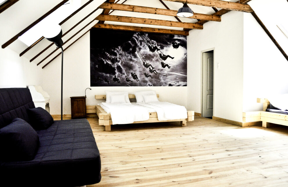 Quirky wooden loft beds featuring distinctly thick cargo netting perfectly at the Kőleves Inn