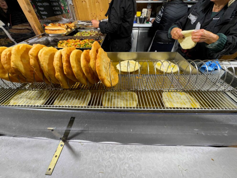 Hungarian Lángos topped with red onion and bacon