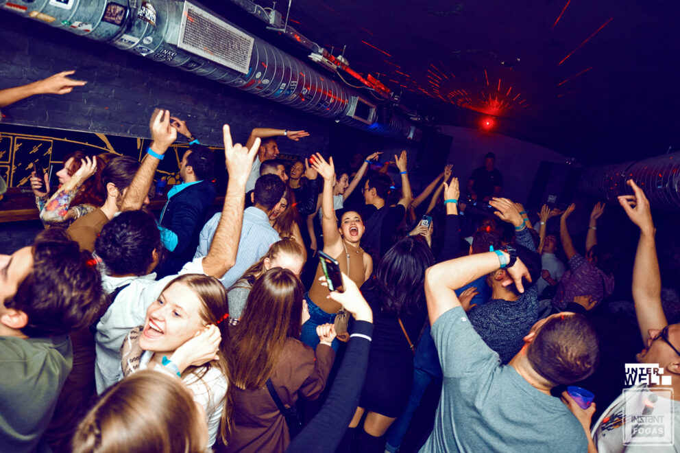 A totally black, deeply fog-filled room beautifully cut precisely by bright club lasers