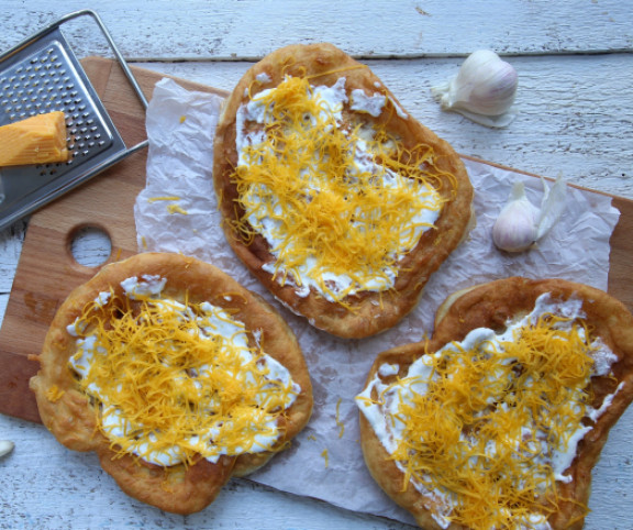 Lángos, the most popular Hungarian street food, with cheese and sour cream