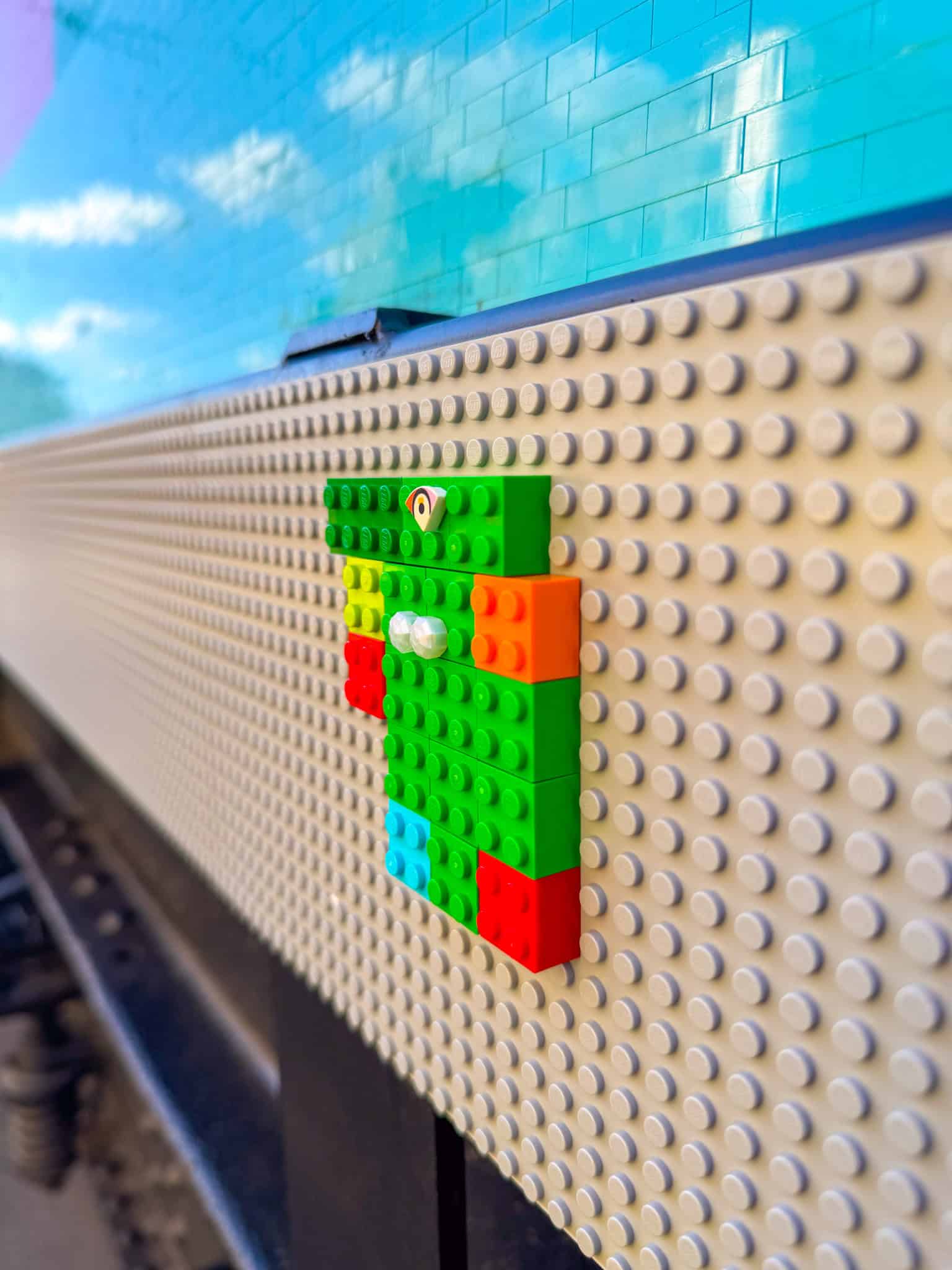 Intricate layers of standard LEGO bricks forming the solid side doors of the tram