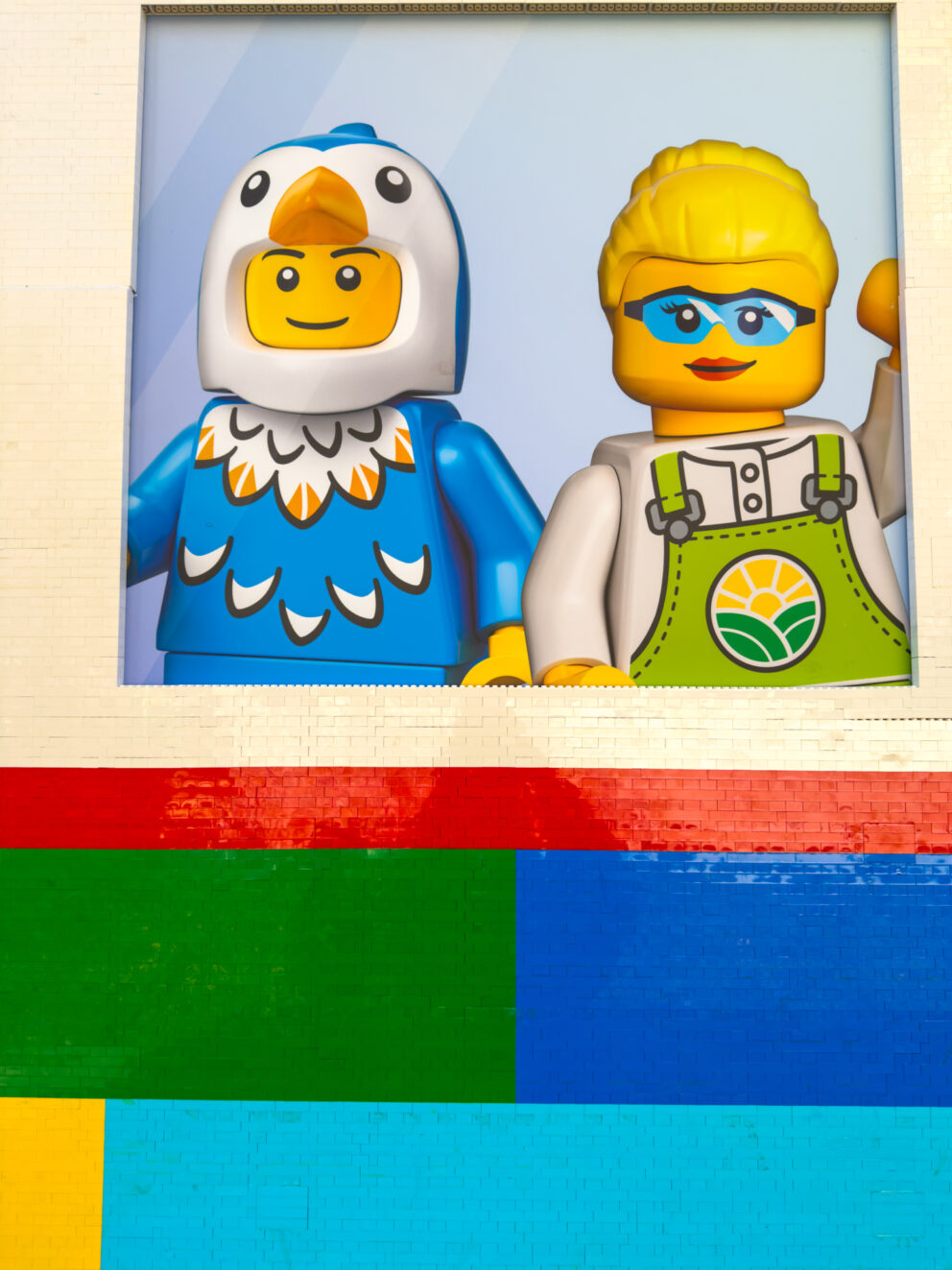 Highly detailed LEGO side characters cleanly commuting inside the massive yellow tram