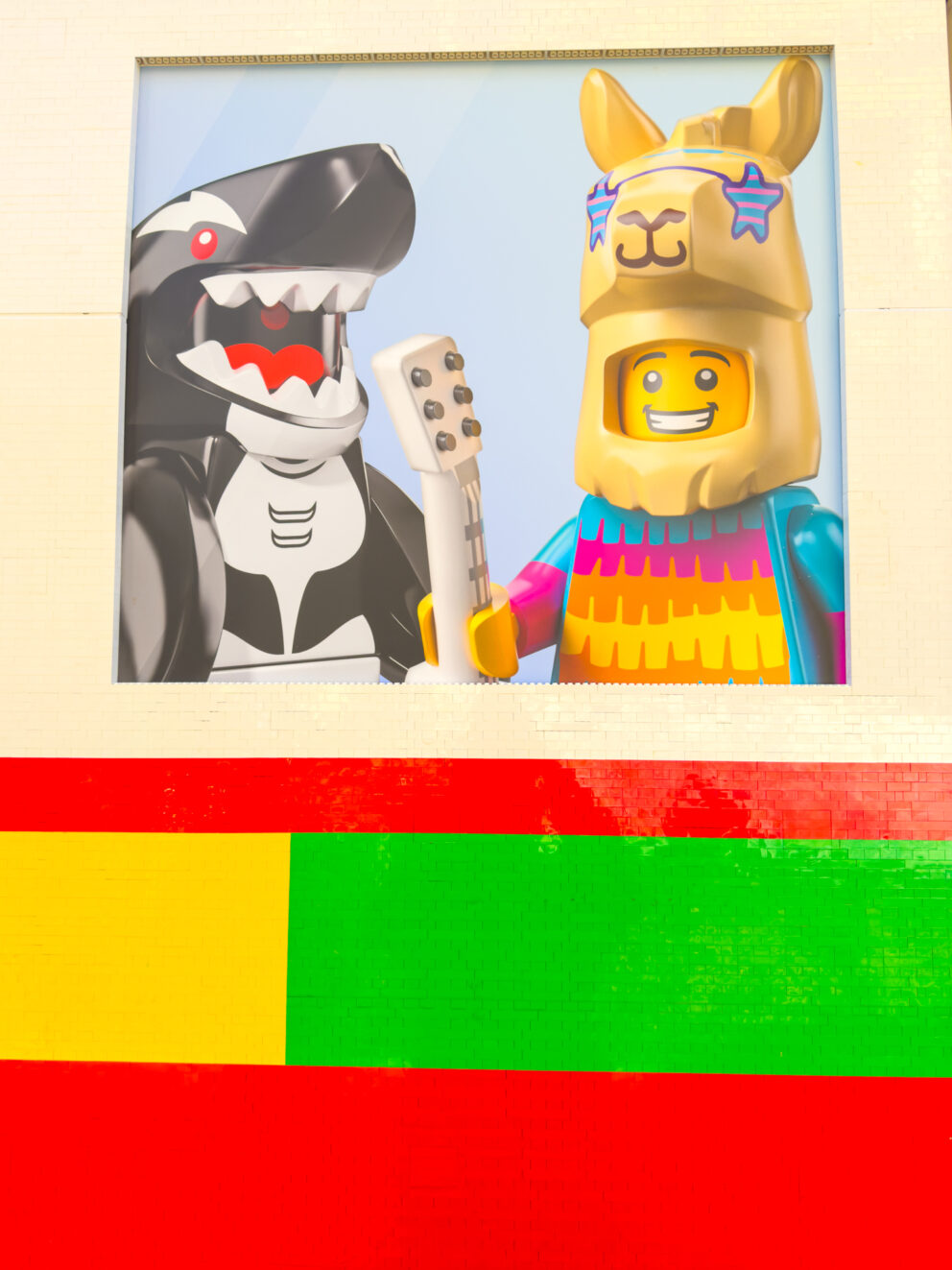 A deeply humorous brick-built orca and llama standing cheerfully inside the tram carriage